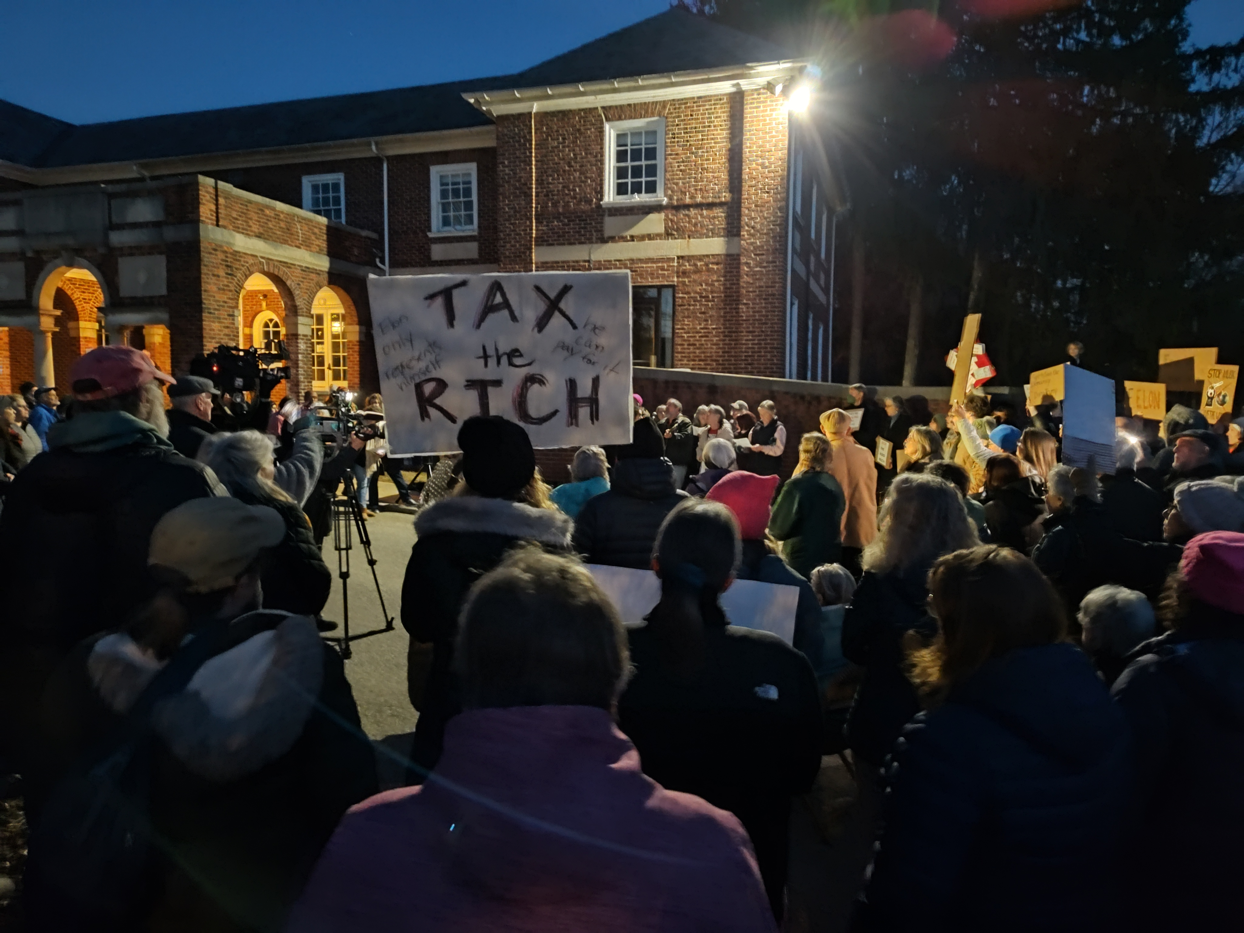 Protest with Sign showing Eat the Rich